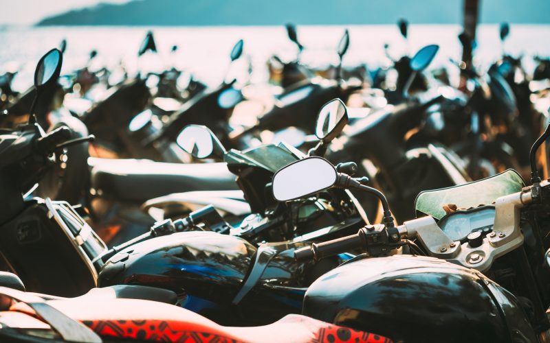 Motorbikes, motorcycles scooters parked in row in city street. Close up of details. Bikes